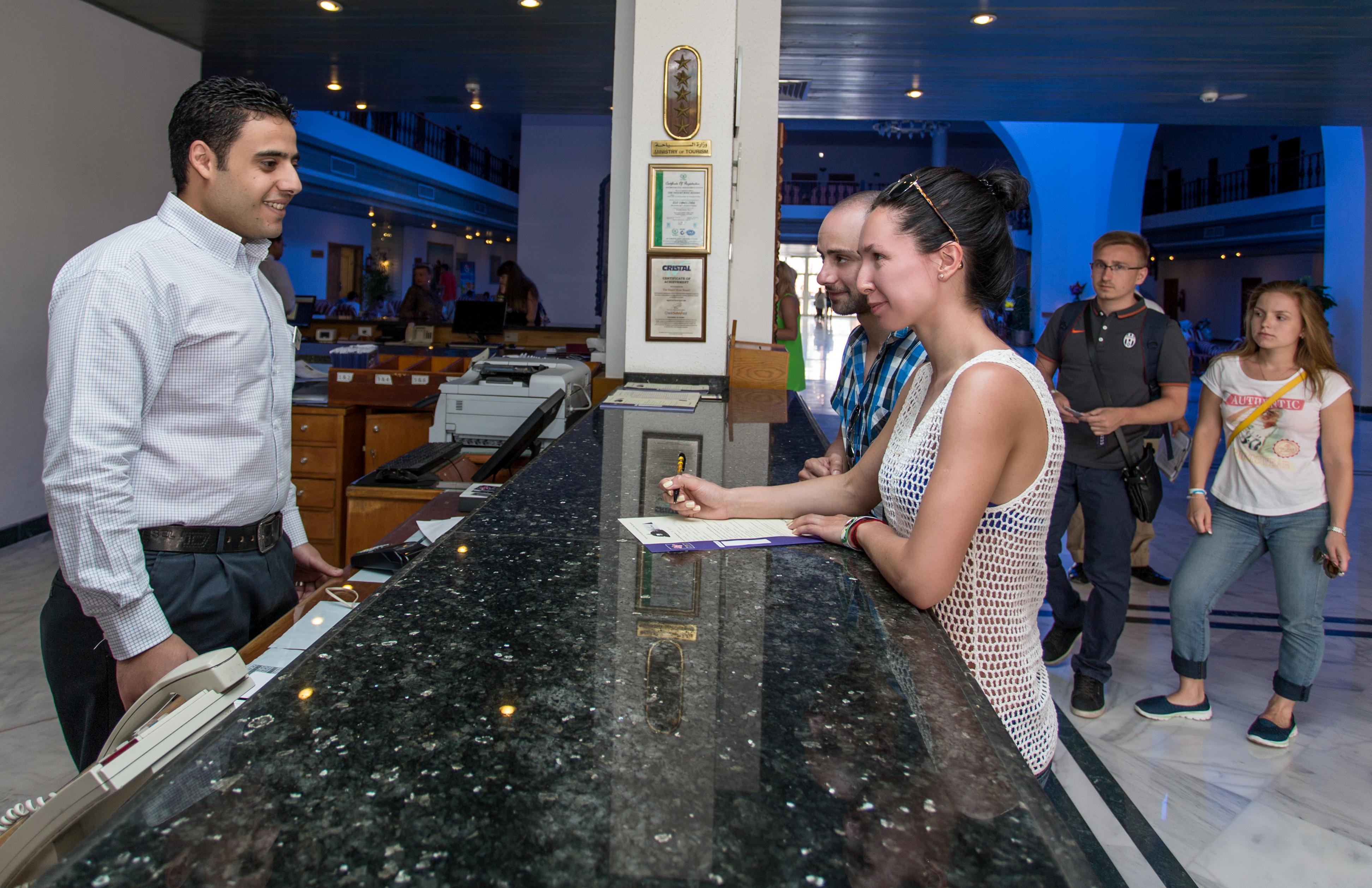 Desert Rose Resort Hurghada Exterior photo A guest checking in at the front desk of a hotel
